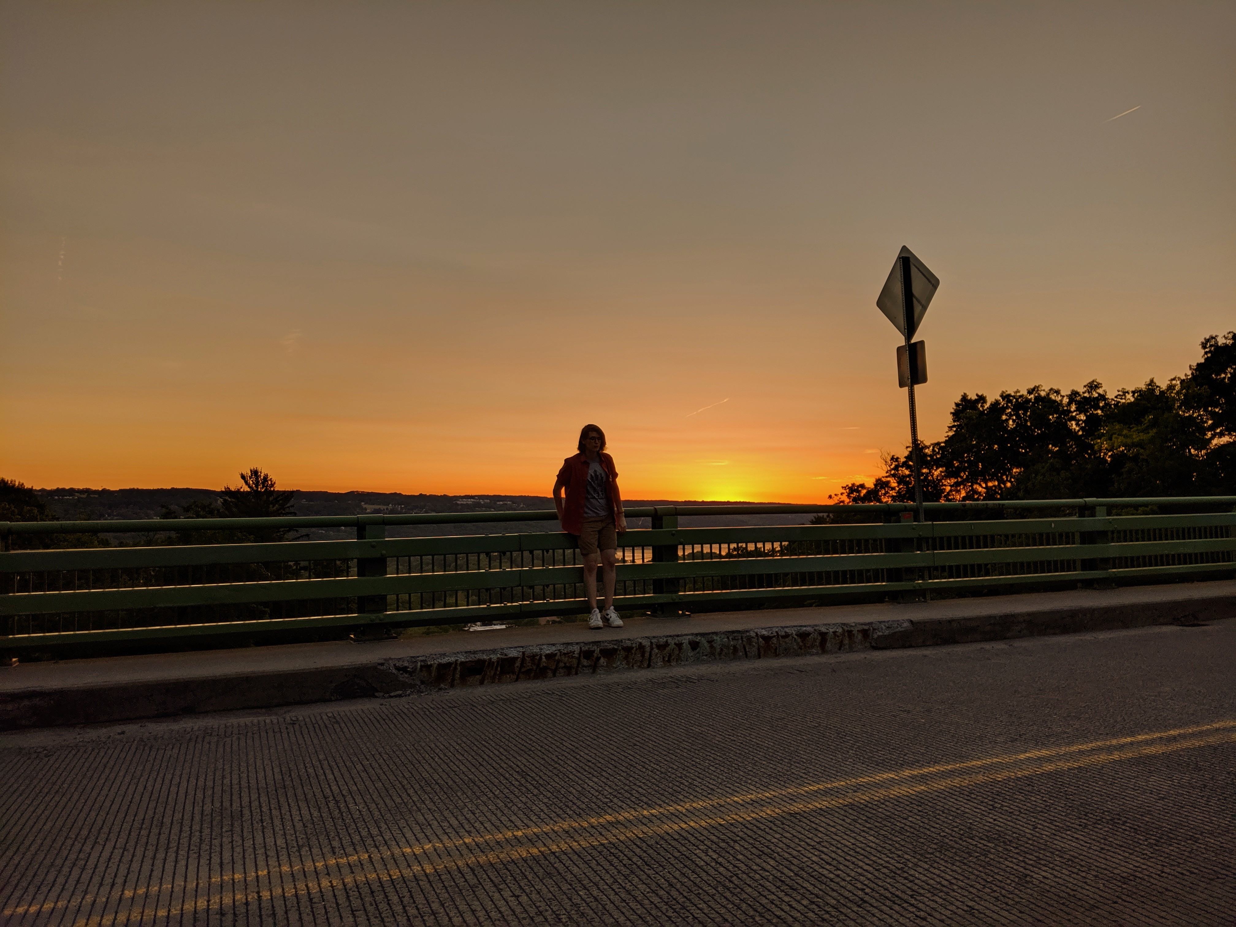 me standing on a bridge in Ithaca, New York at sunset